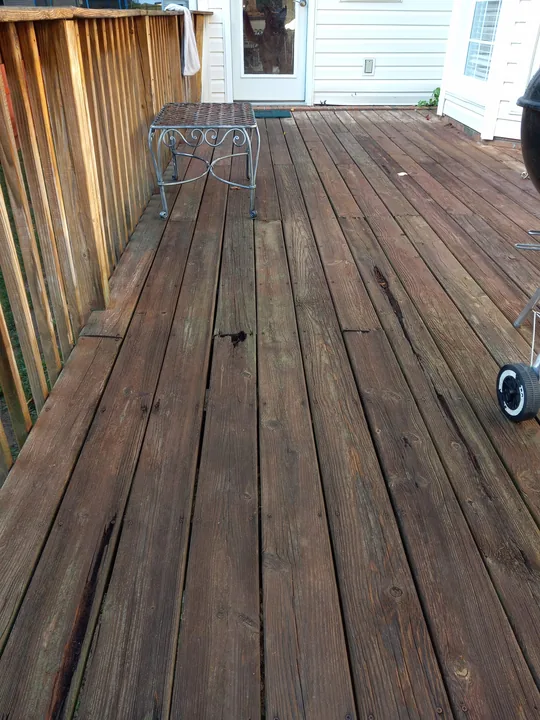 Close view of wood deck boards near a house wall