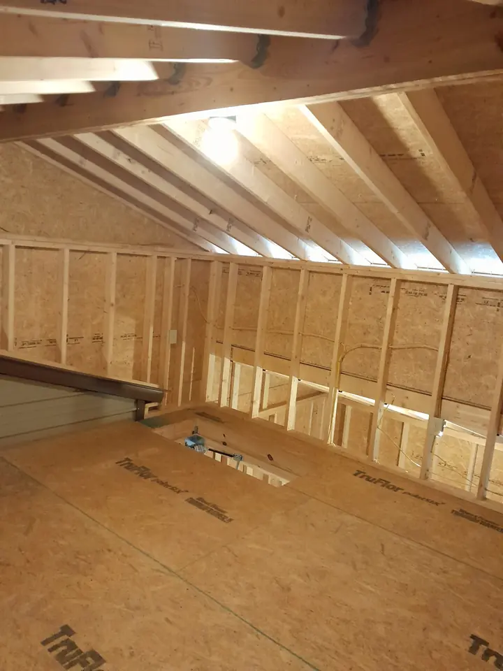 Wood wall framing and roof structure inside an outbuilding